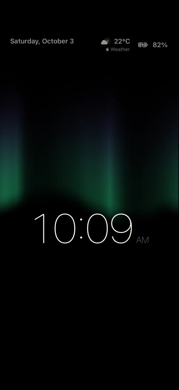 Lumen Desk Clock on iPhone: the Aurora effect, with green curtains of light above the time 10:09 AM, and the date, the weather from Apple Weather and the battery level in the corners